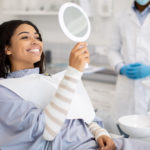 Woman Looking At Her Newly Whitened Teeth