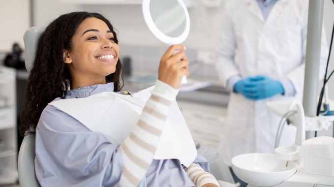 Woman Looking At Her Newly Whitened Teeth
