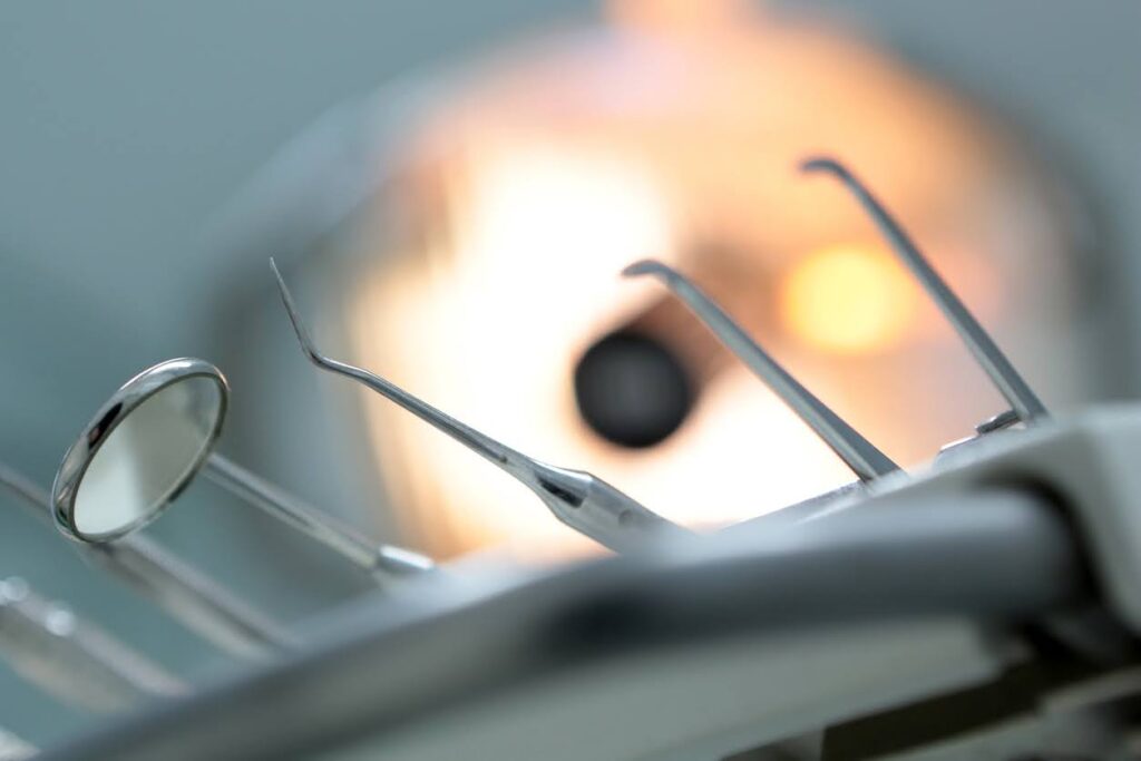 Dentists Tools on a Metal Tray with Blurry Background. Sharp objects can make the dentist scary for children.